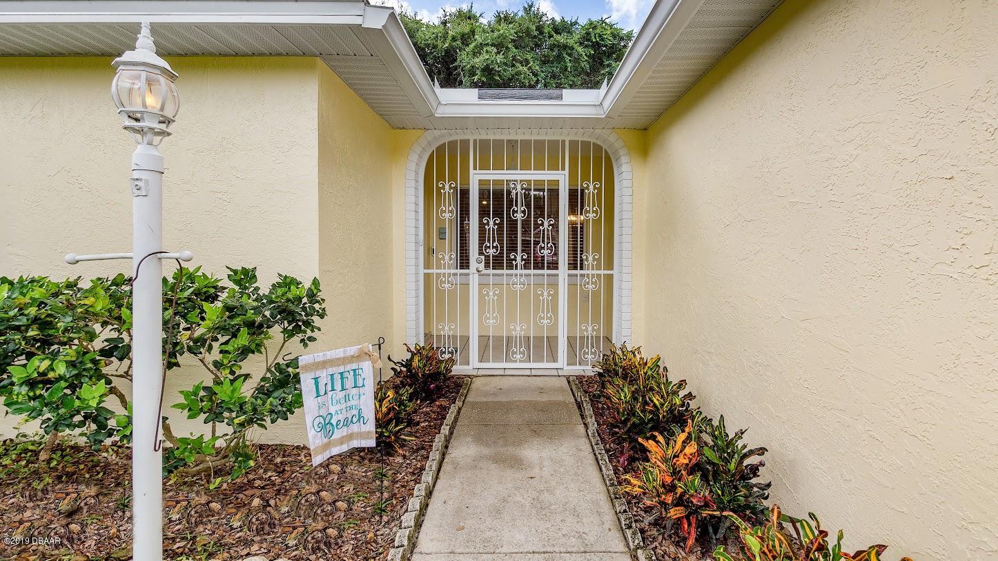 73 Glenview Avenue Ponce Inlet, FL 32127 - Photo 3 of 36 walking to front door