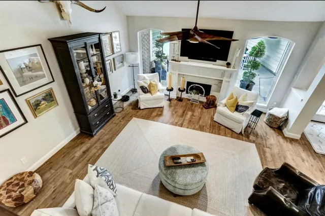 a living room with furniture a flat screen tv and a fireplace