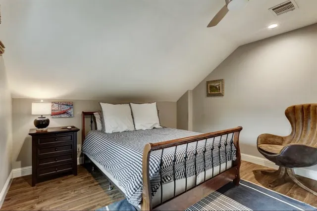 a bedroom with a bed and chair