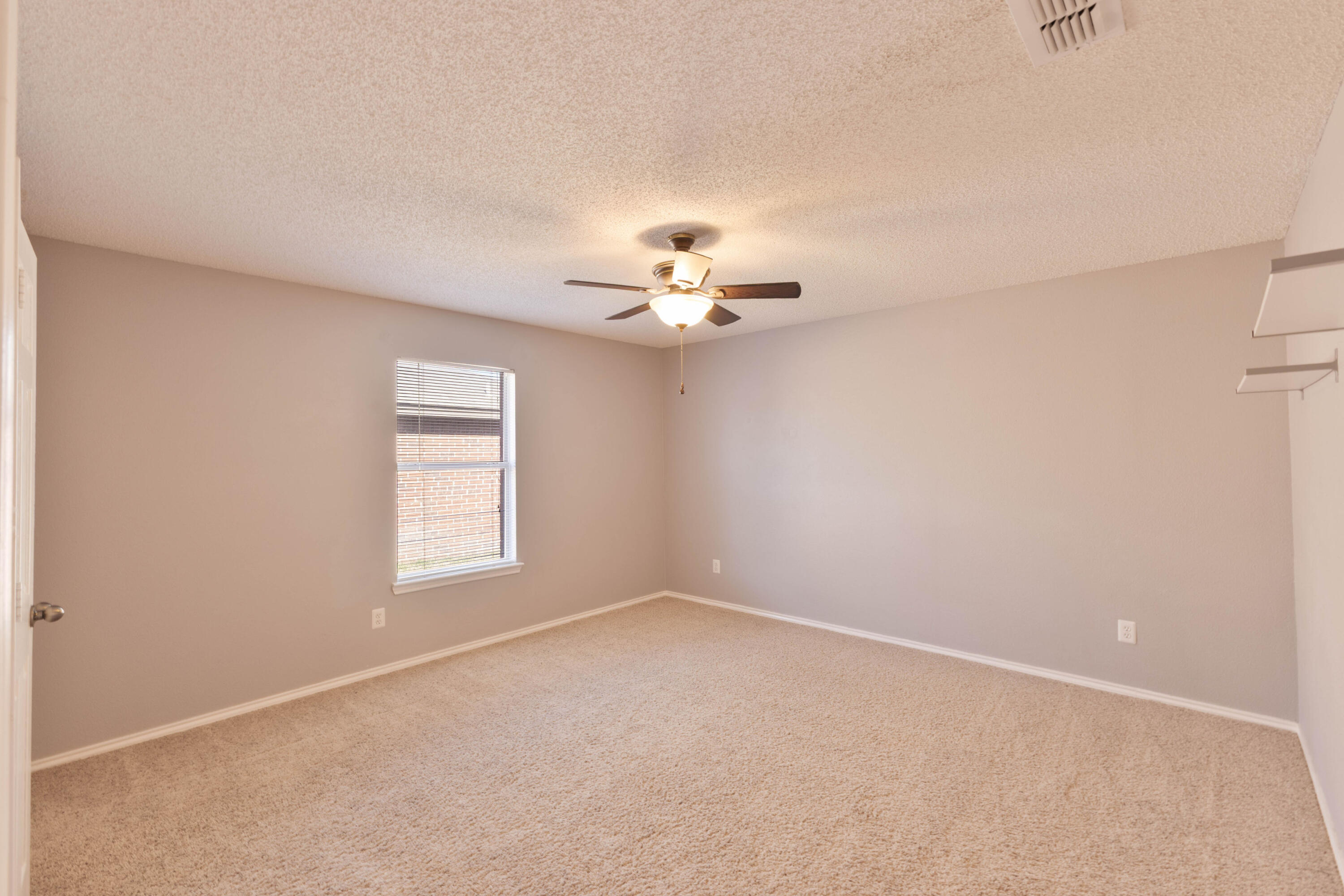 5917 88th Place Lubbock, TX 79424 - Photo 11 of 18 wooden floor in an empty room with a window