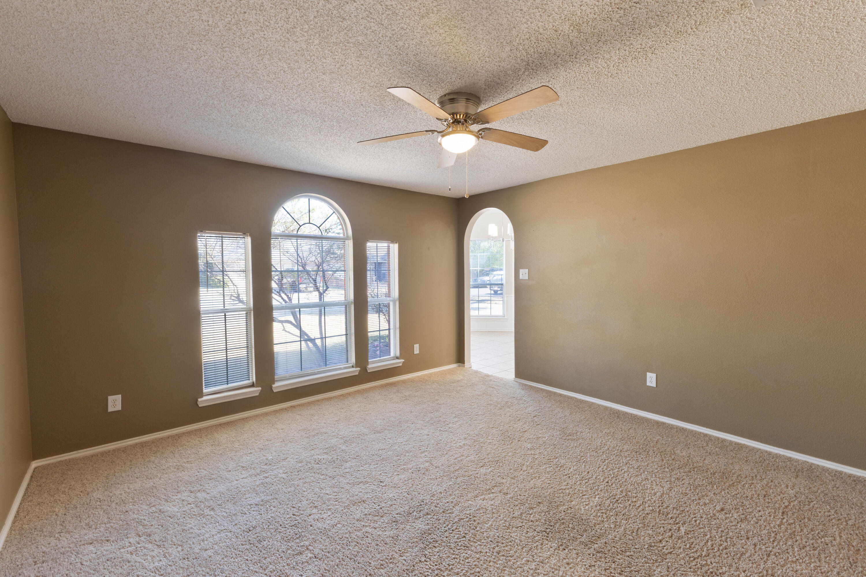 5917 88th Place Lubbock, TX 79424 - Photo 5 of 18 an empty room with windows and ceiling fan