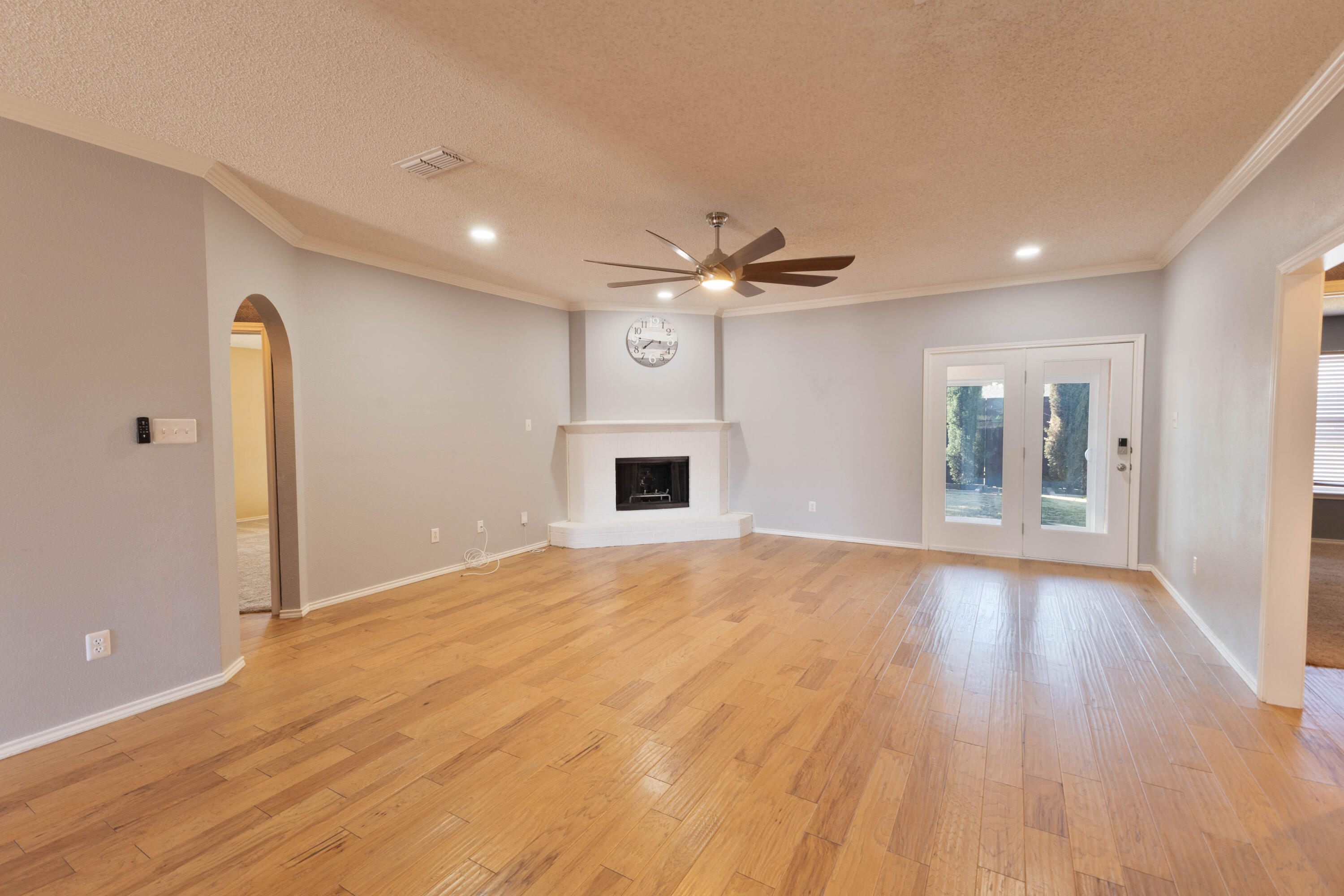 5917 88th Place Lubbock, TX 79424 - Photo 6 of 18 a view of an empty room with window and wooden floor