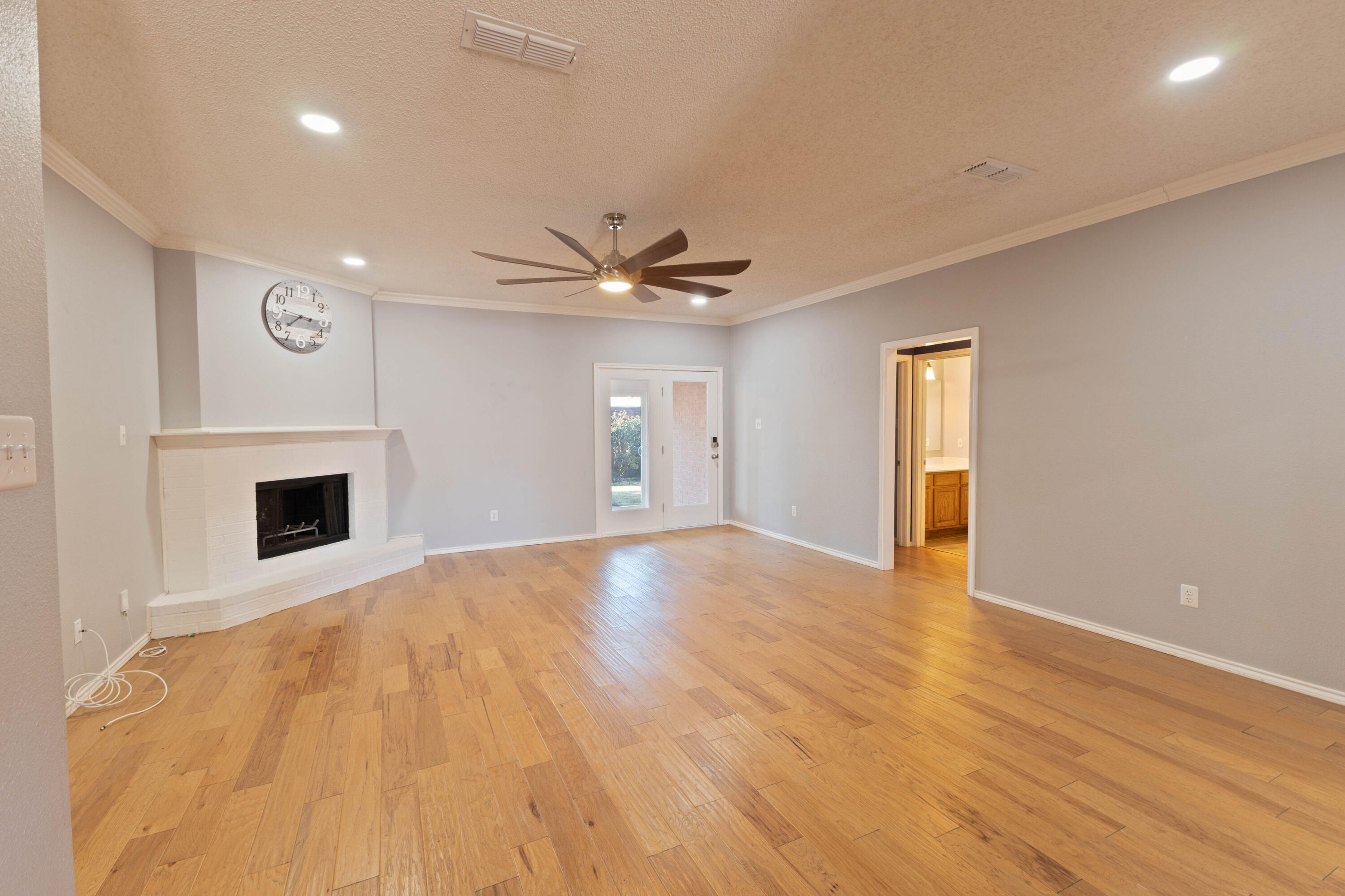 5917 88th Place Lubbock, TX 79424 - Photo 7 of 18 a view of an empty room with a fireplace