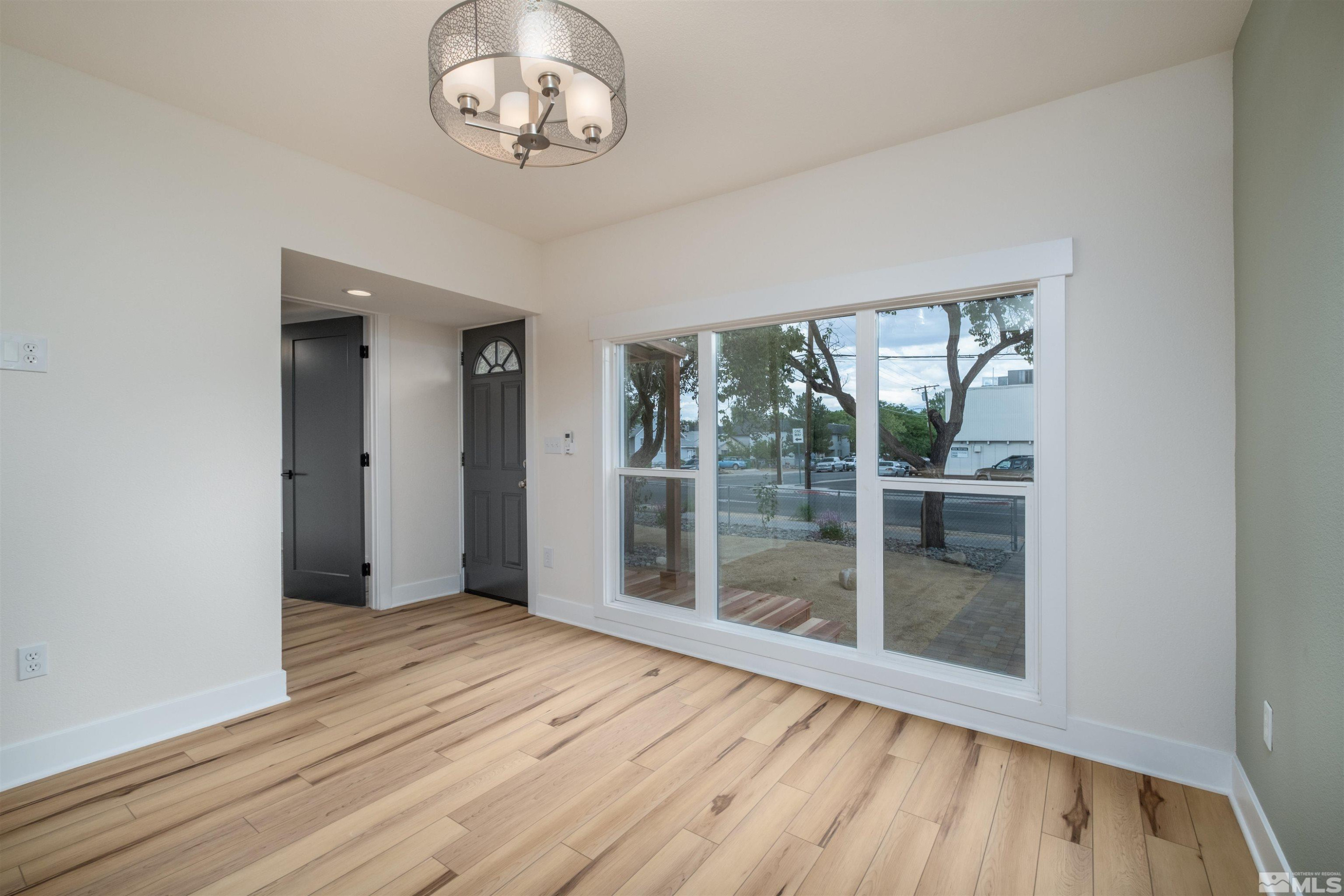 1401 Locust Street Reno, NV 89502 - Photo 12 of 29 en empty room with wooden floor and windows