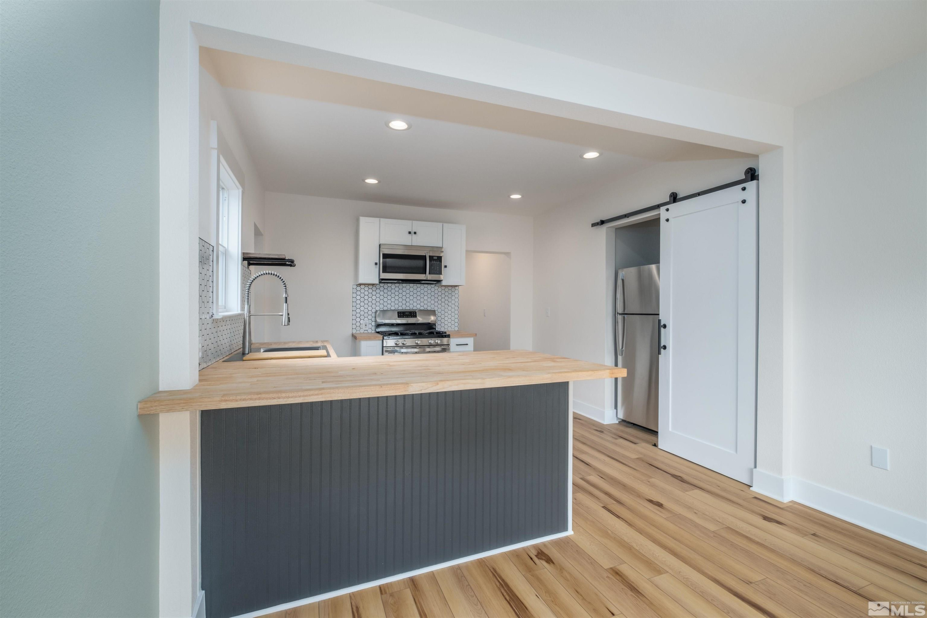 1401 Locust Street Reno, NV 89502 - Photo 13 of 29 a view of kitchen with refrigerator stove and wooden floor