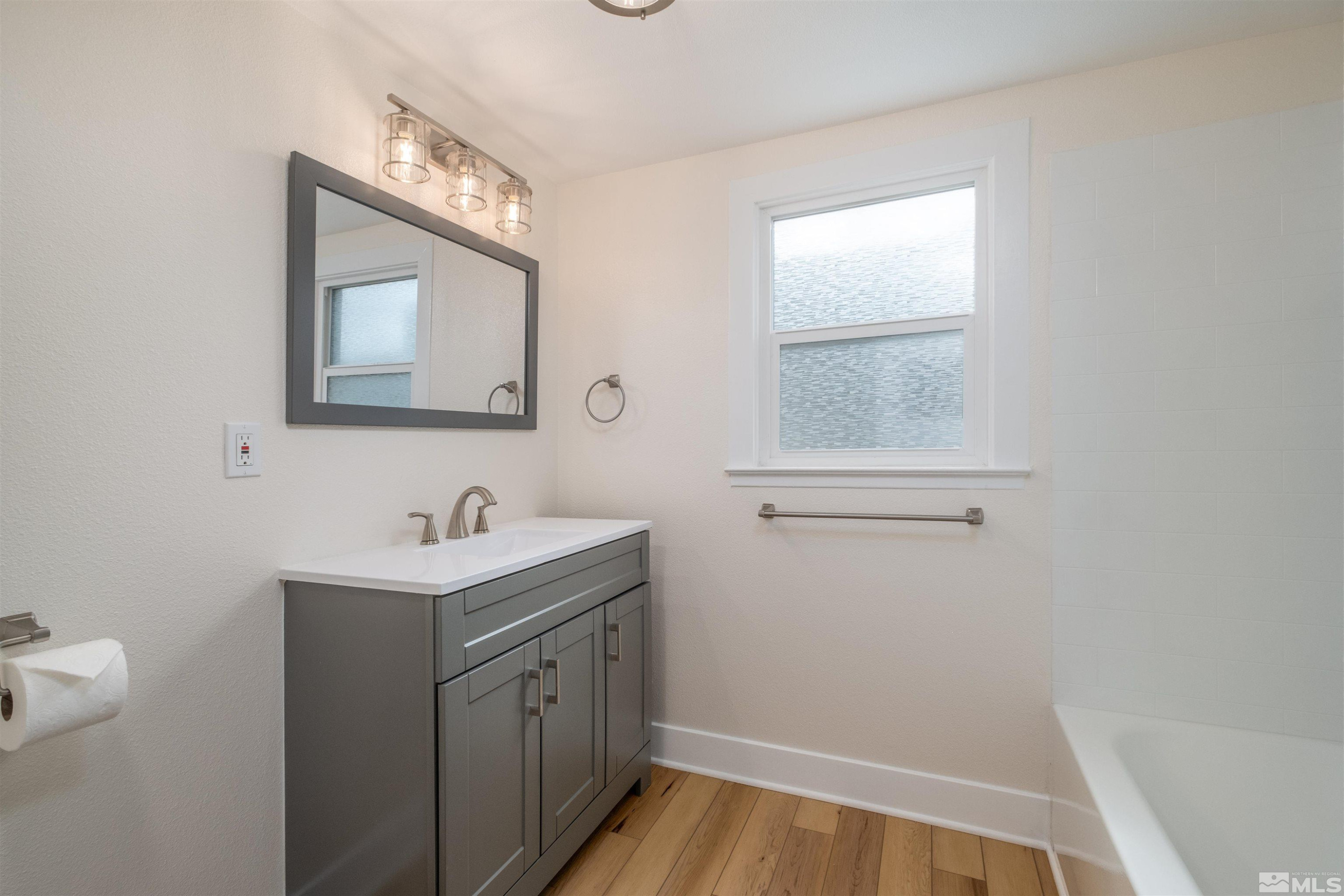 1401 Locust Street Reno, NV 89502 - Photo 20 of 29 a bathroom with a toilet sink and mirror