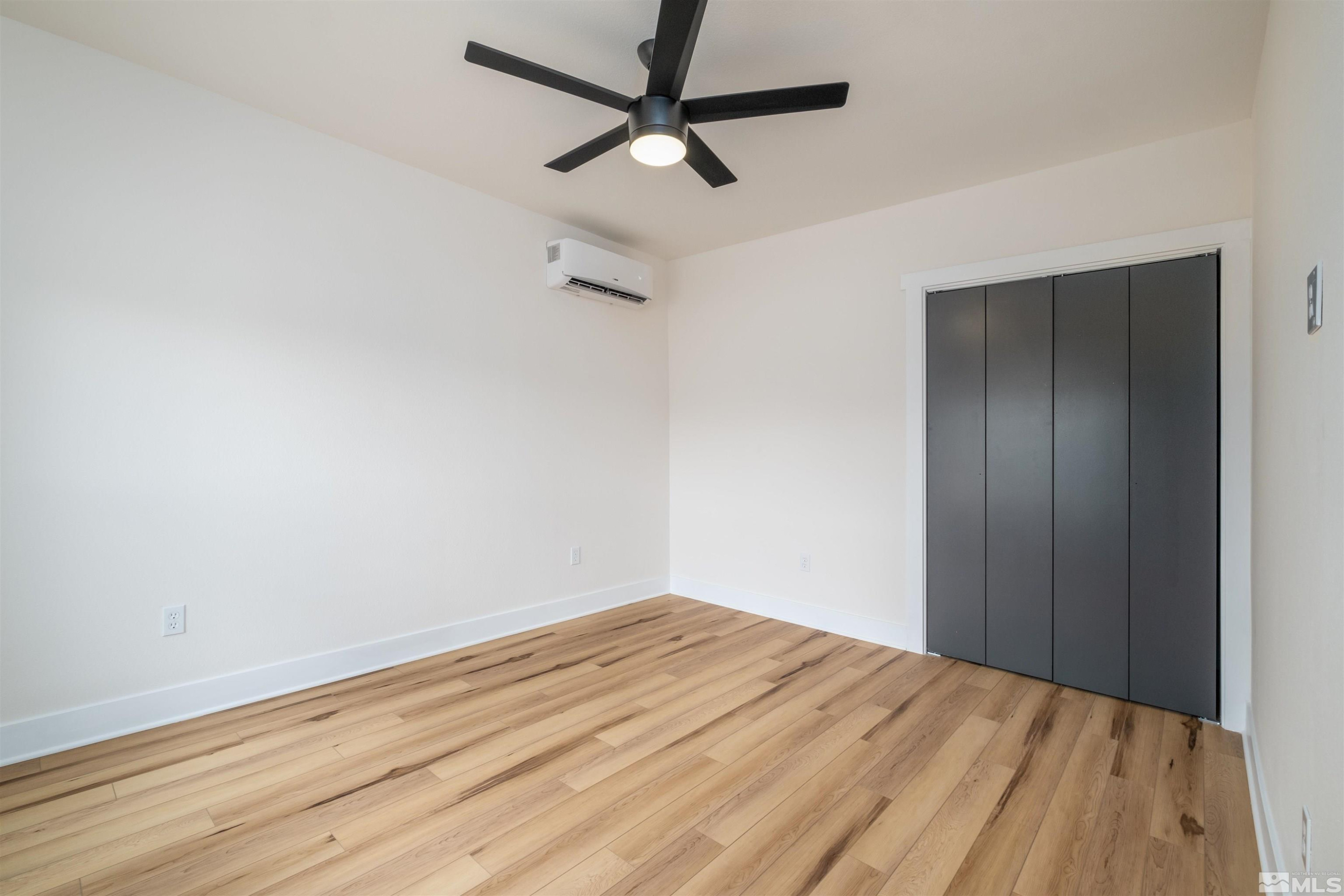1401 Locust Street Reno, NV 89502 - Photo 22 of 29 a view of a room with wooden floor and a ceiling fan