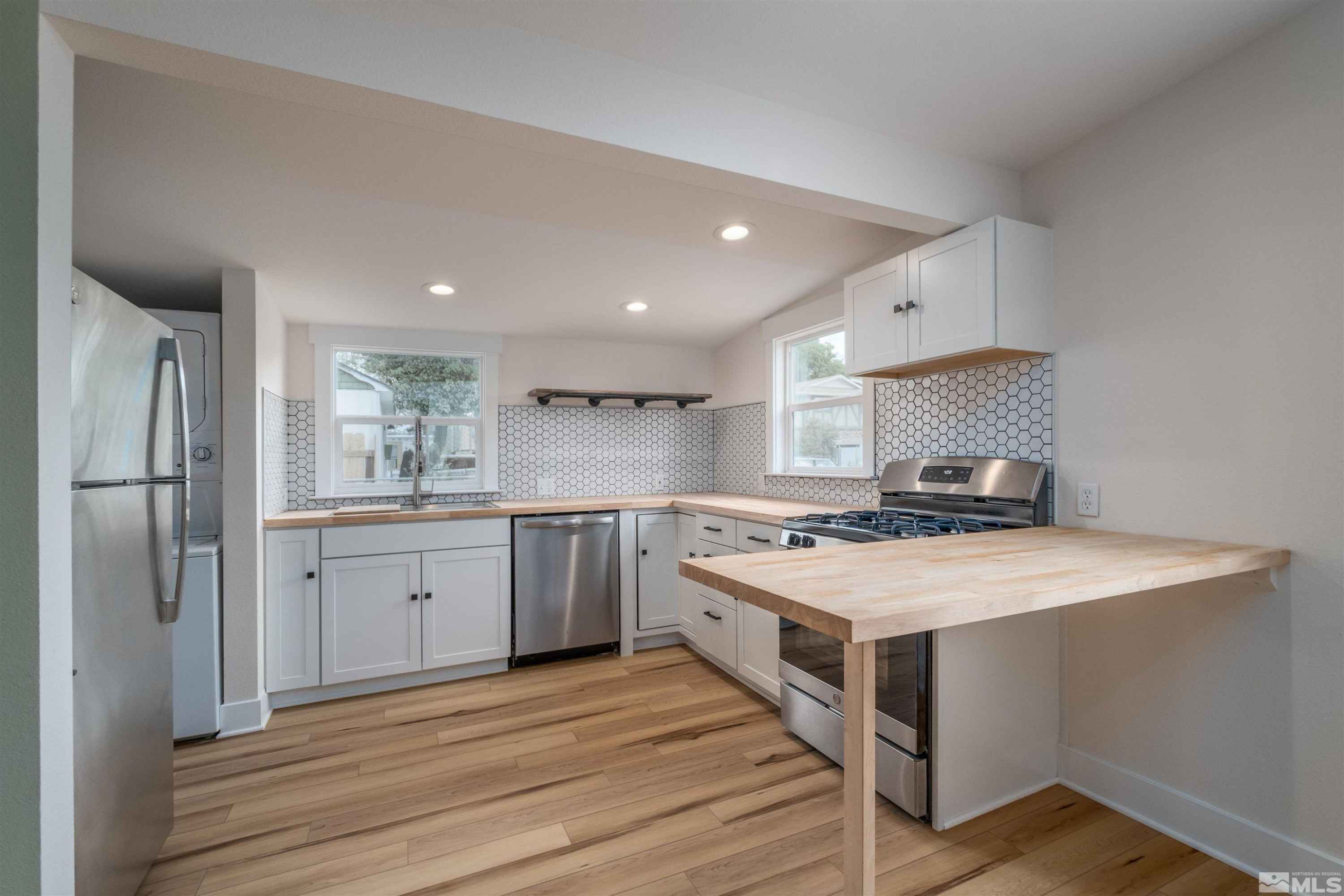 1401 Locust Street Reno, NV 89502 - Photo 24 of 29 a kitchen with a stove a sink and a refrigerator
