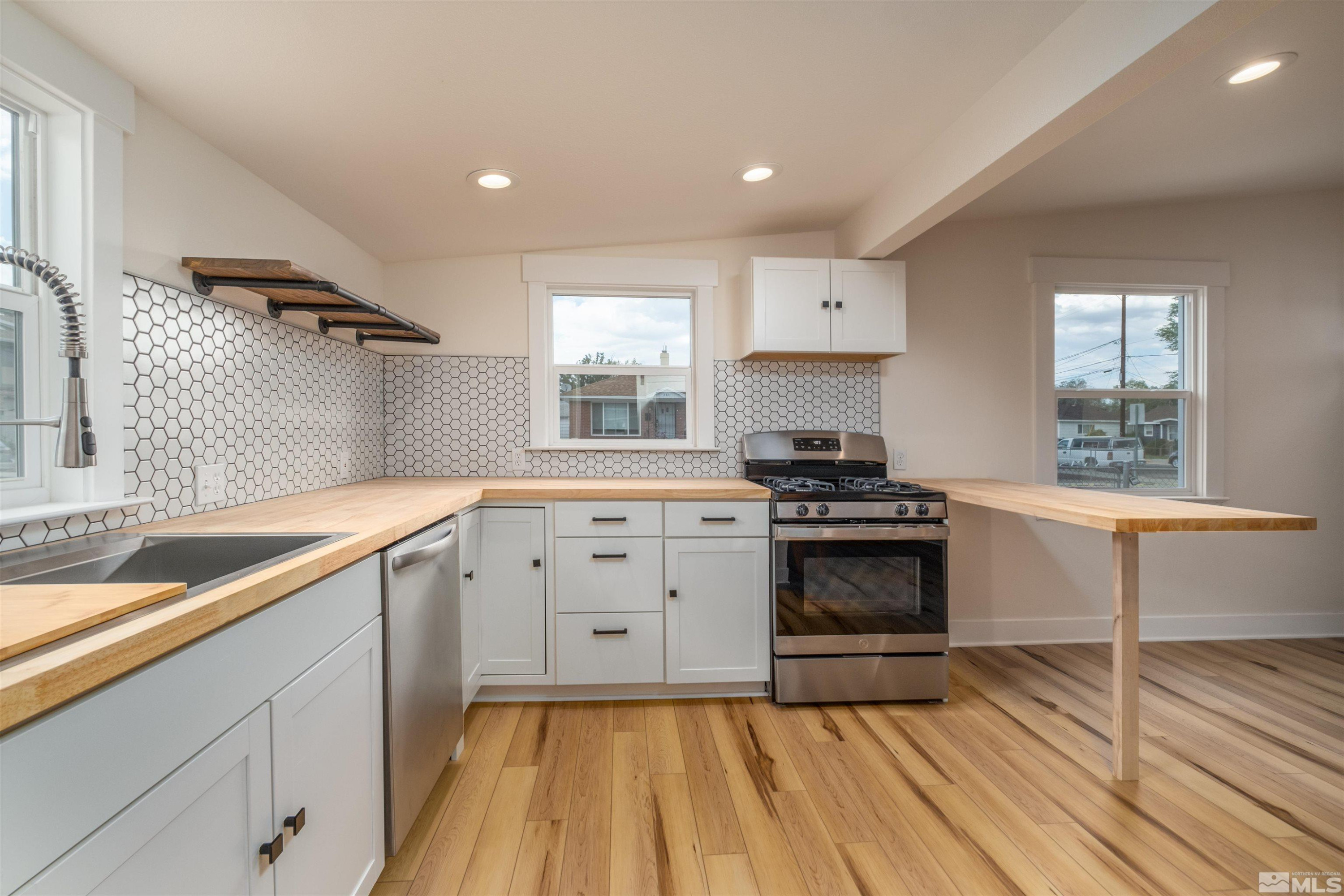 1401 Locust Street Reno, NV 89502 - Photo 25 of 29 a kitchen with a sink stove and cabinets