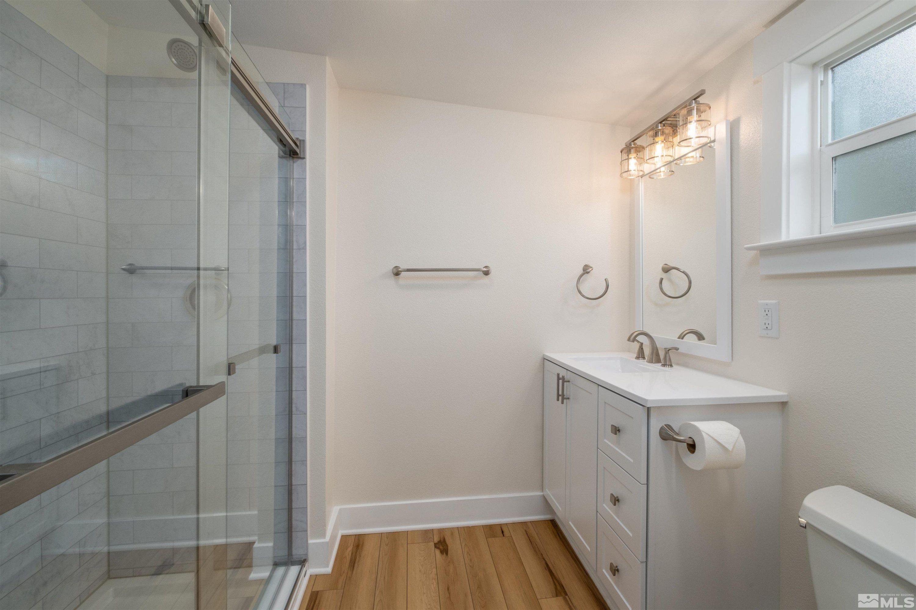 1401 Locust Street Reno, NV 89502 - Photo 27 of 29 a bathroom with a sink and mirror with toilet