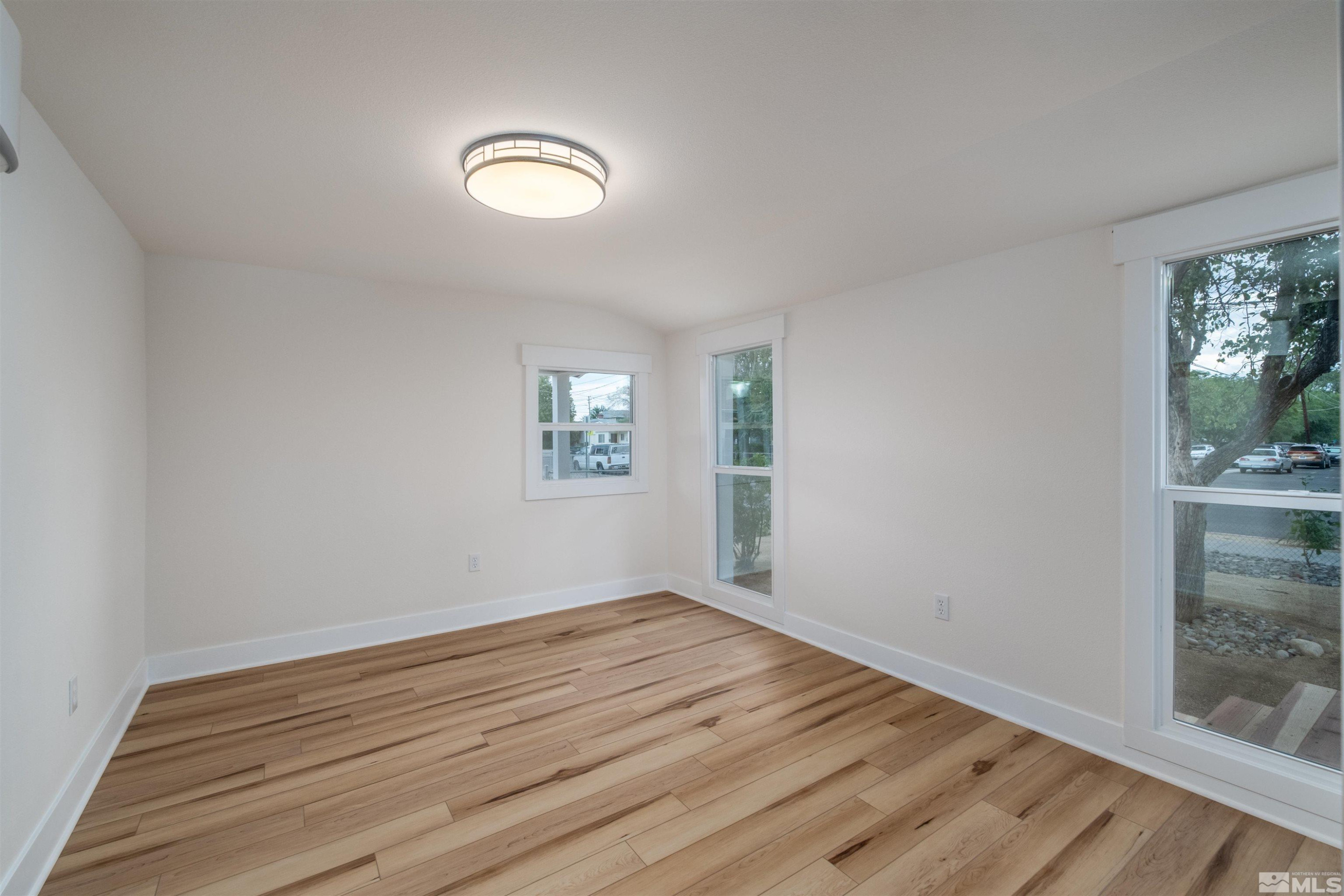 1401 Locust Street Reno, NV 89502 - Photo 10 of 29 an empty room with wooden floor and windows