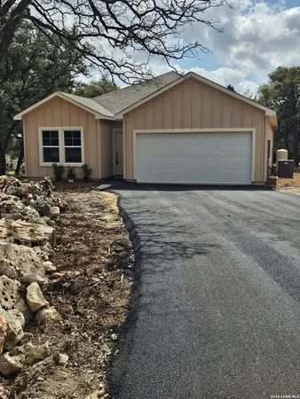 a view of a house with a yard and garage