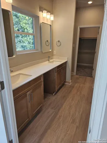 a bathroom with a sink vanity and mirror