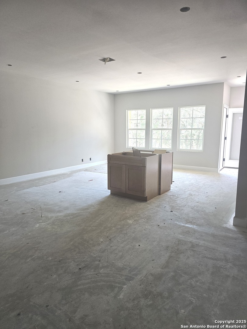 628 Winding River Lane Spring Branch, TX 78070 - Photo 2 of 16 an empty room with windows and cabinet