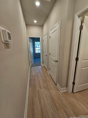 a view of a hallway with wooden floor