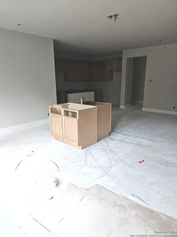 a view of a room with wooden cabinets