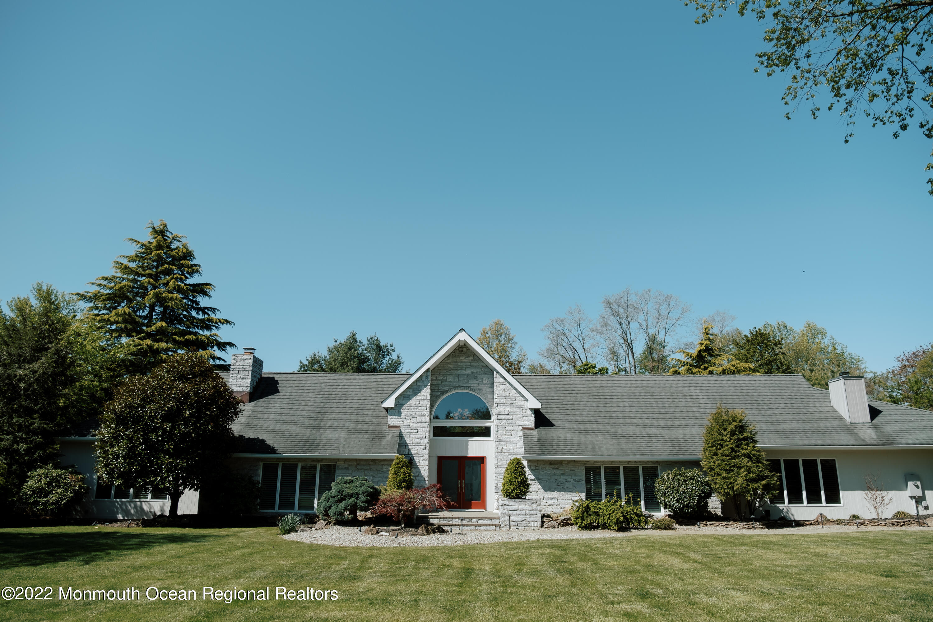 a front view of a house with a garden and deck