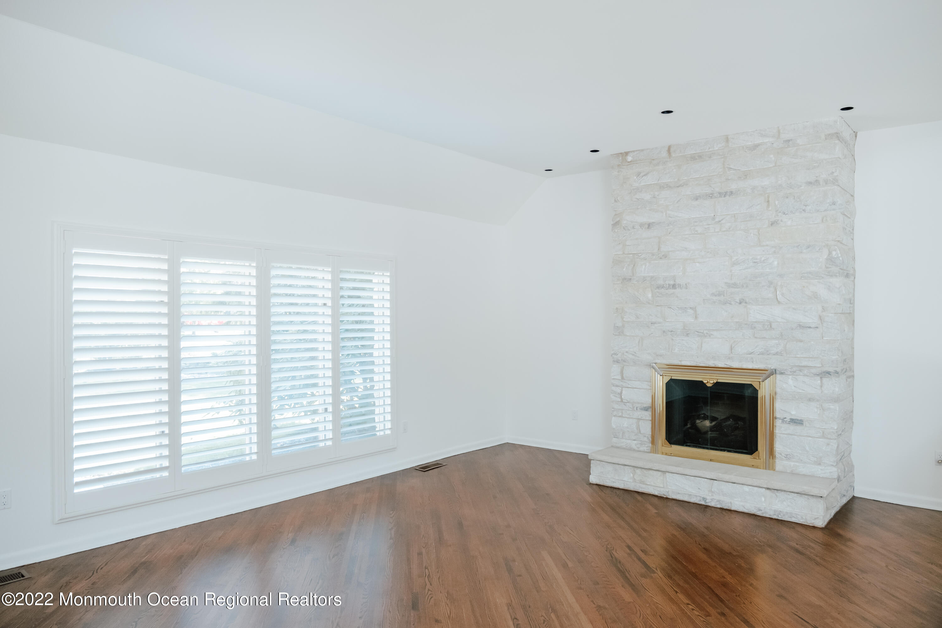 97 Mitchell Place Little Silver, NJ 07739 - Photo 13 of 21 a view of an empty room with wooden floor and a fireplace