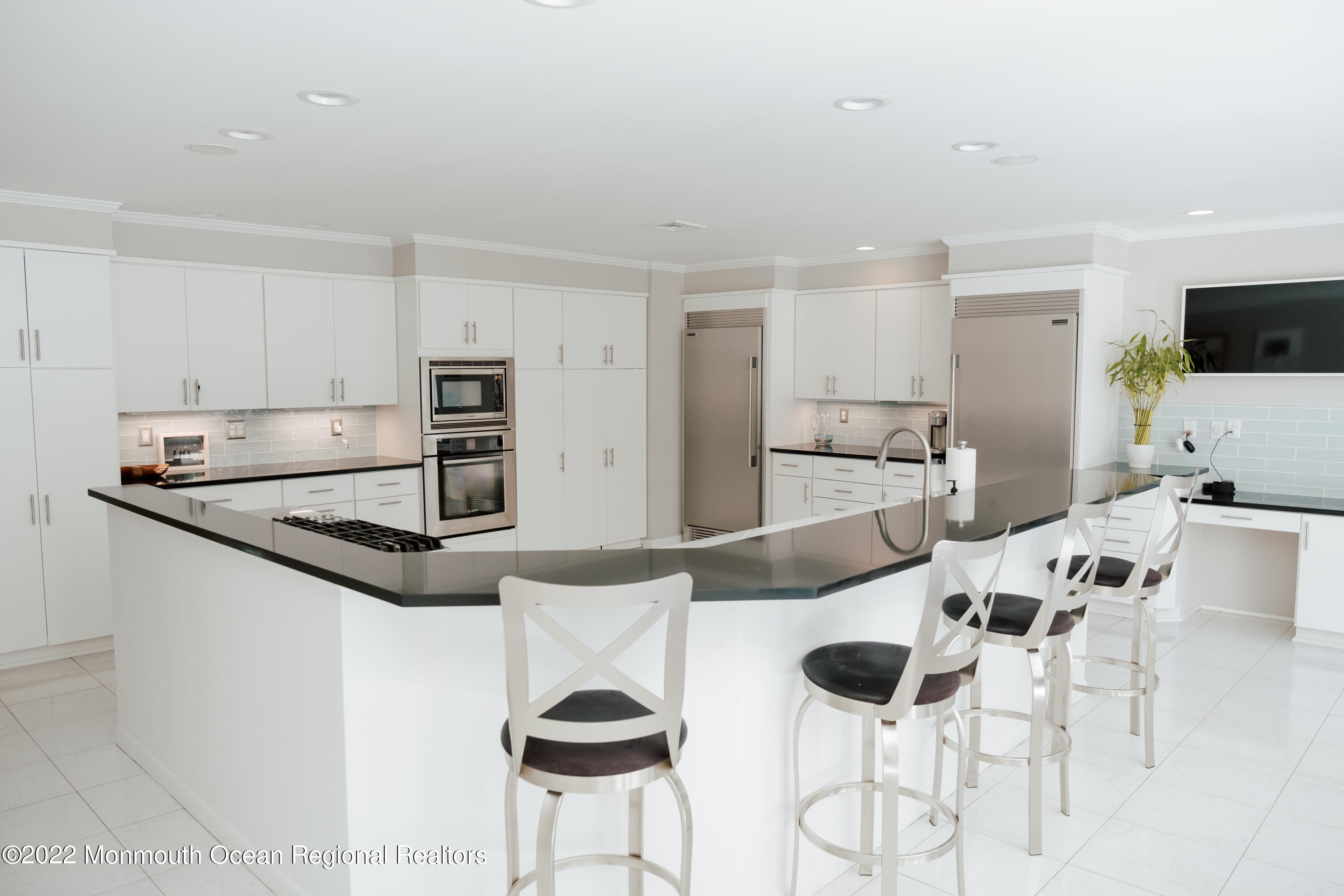 97 Mitchell Place Little Silver, NJ 07739 - Photo 18 of 21 a kitchen with stainless steel appliances kitchen island granite countertop a sink and cabinets