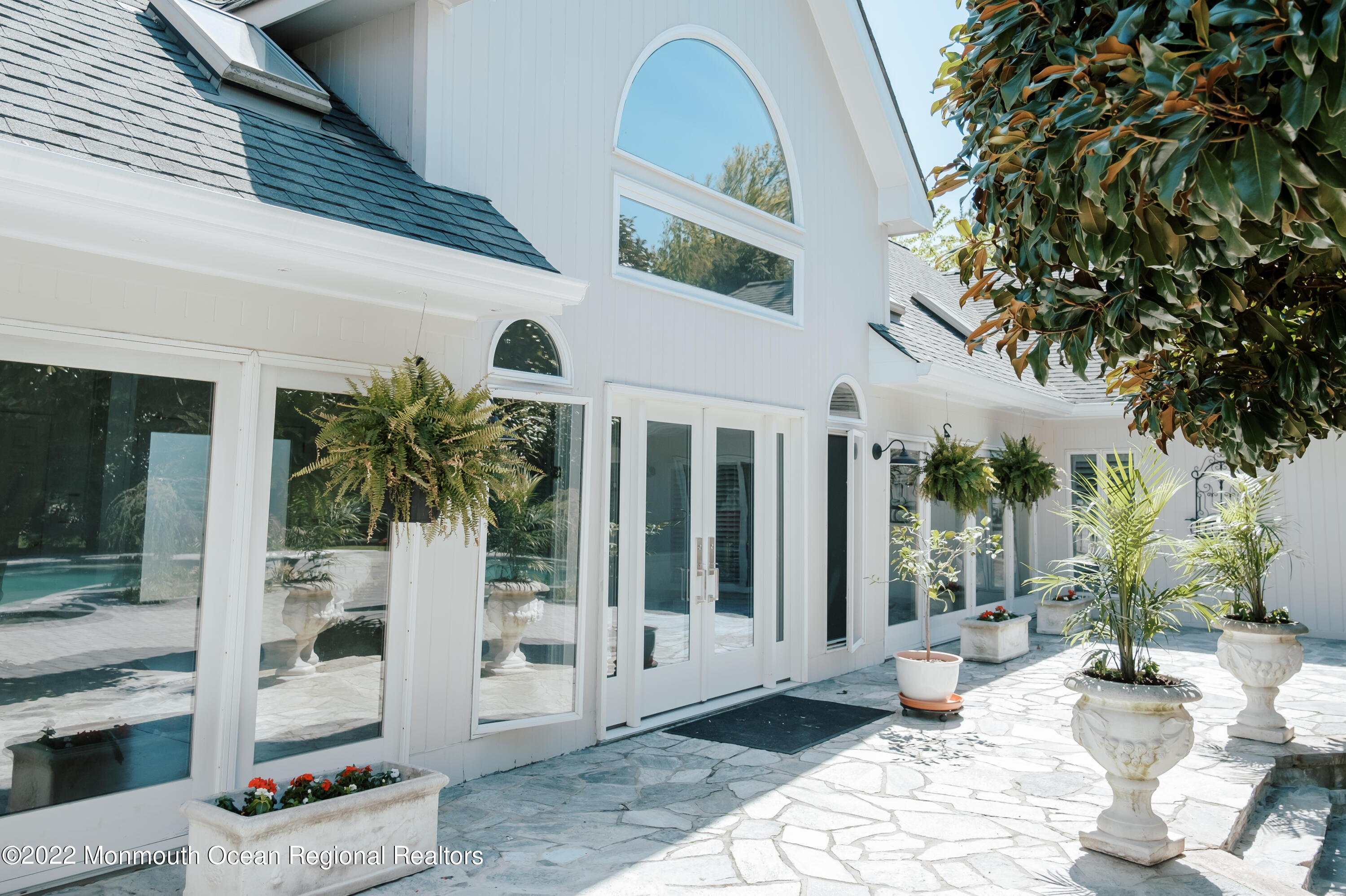 97 Mitchell Place Little Silver, NJ 07739 - Photo 4 of 21 a view of a patio with table and chairs and potted plants