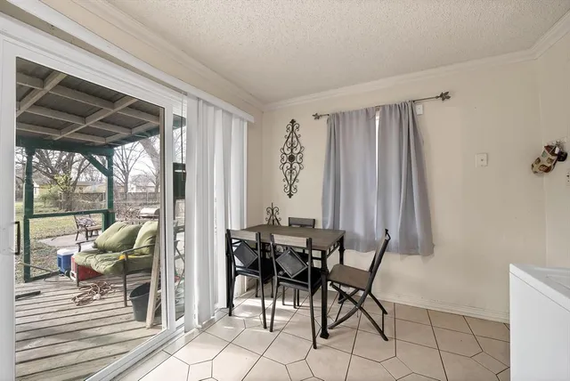 a dining room with furniture and large windows