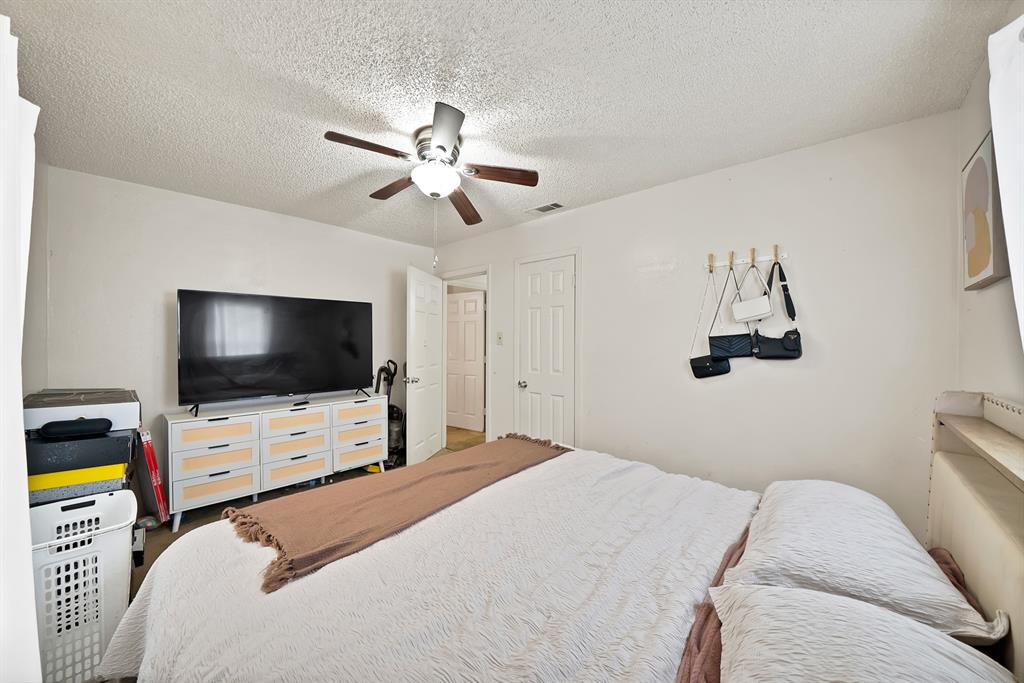 4153 Doyle Lane Lancaster, TX 75134 - Photo 10 of 20 a bedroom with a bed and a flat screen tv