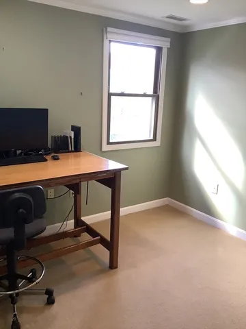 a room with a desk and a window