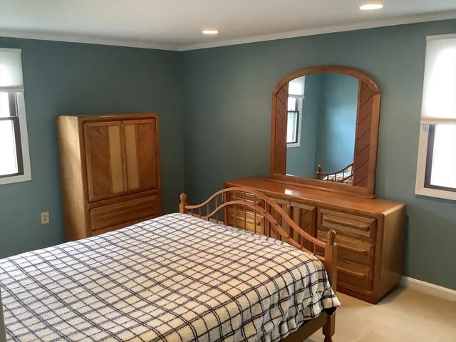 a bedroom with a bed and a mirror