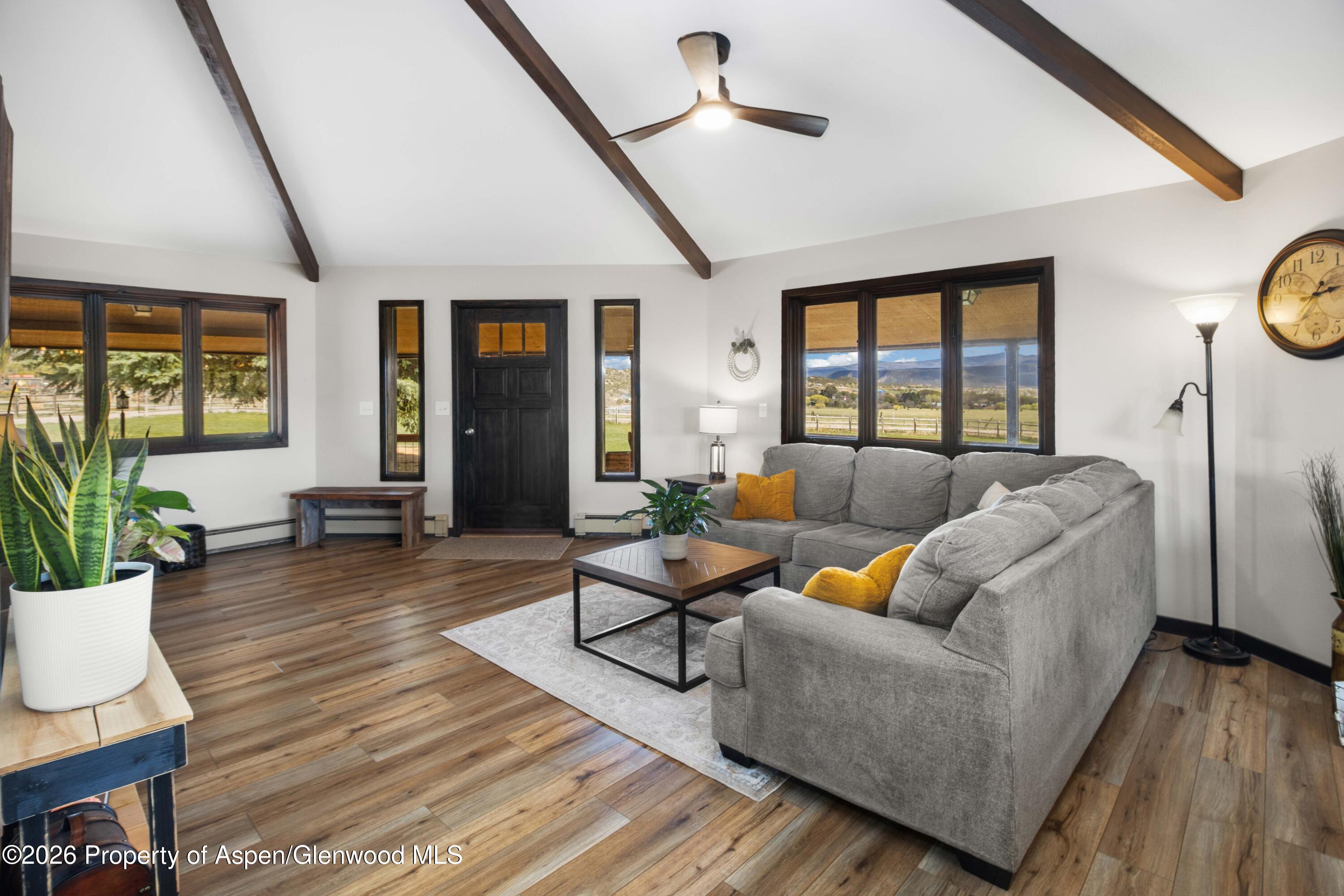 411 County Road 237 Silt, CO 81652 - Photo 23 of 45 a living room with fireplace furniture and a large window