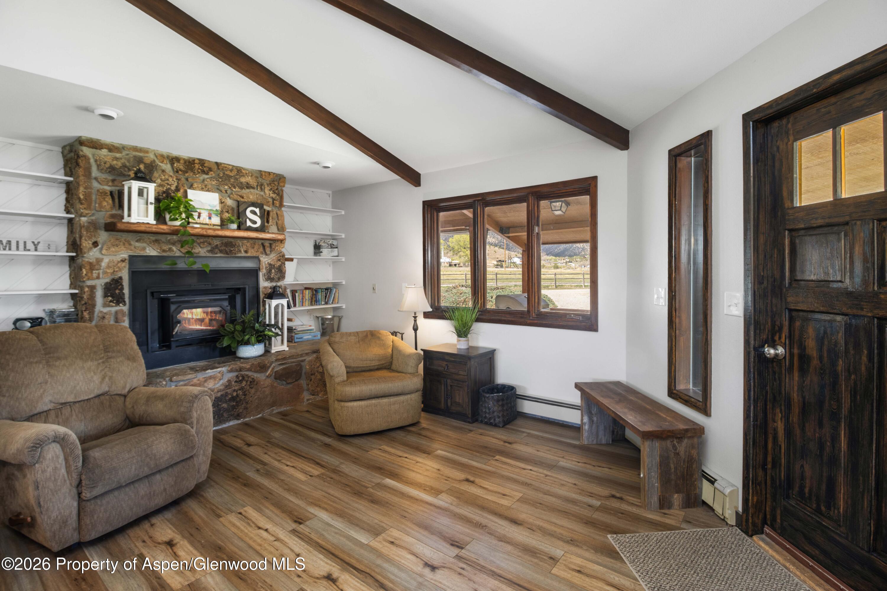 411 County Road 237 Silt, CO 81652 - Photo 24 of 45 a living room with furniture a fireplace and a window