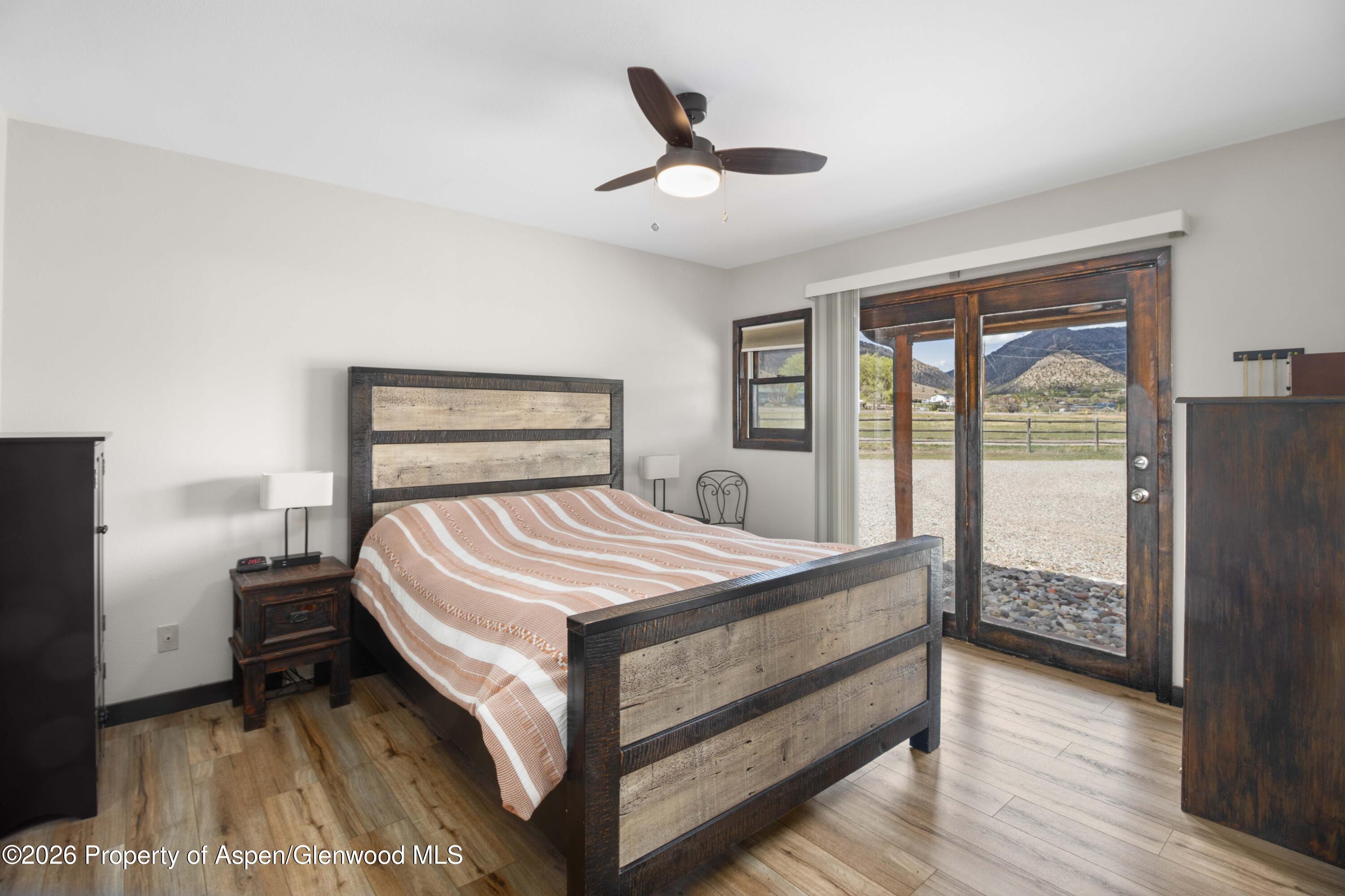 411 County Road 237 Silt, CO 81652 - Photo 31 of 45 a bedroom with a bed and a large window