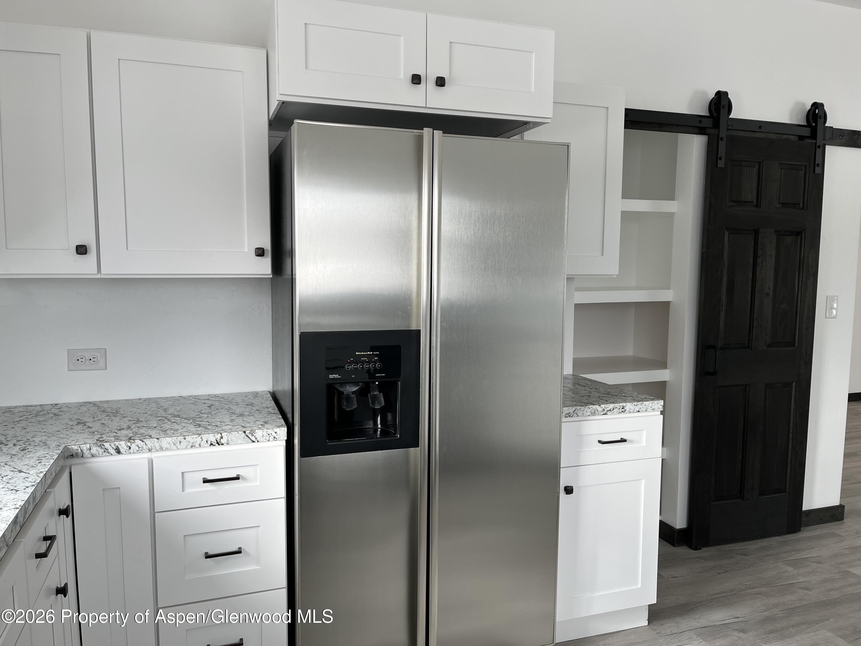 411 County Road 237 Silt, CO 81652 - Photo 41 of 45 a kitchen with white cabinets and refrigerator
