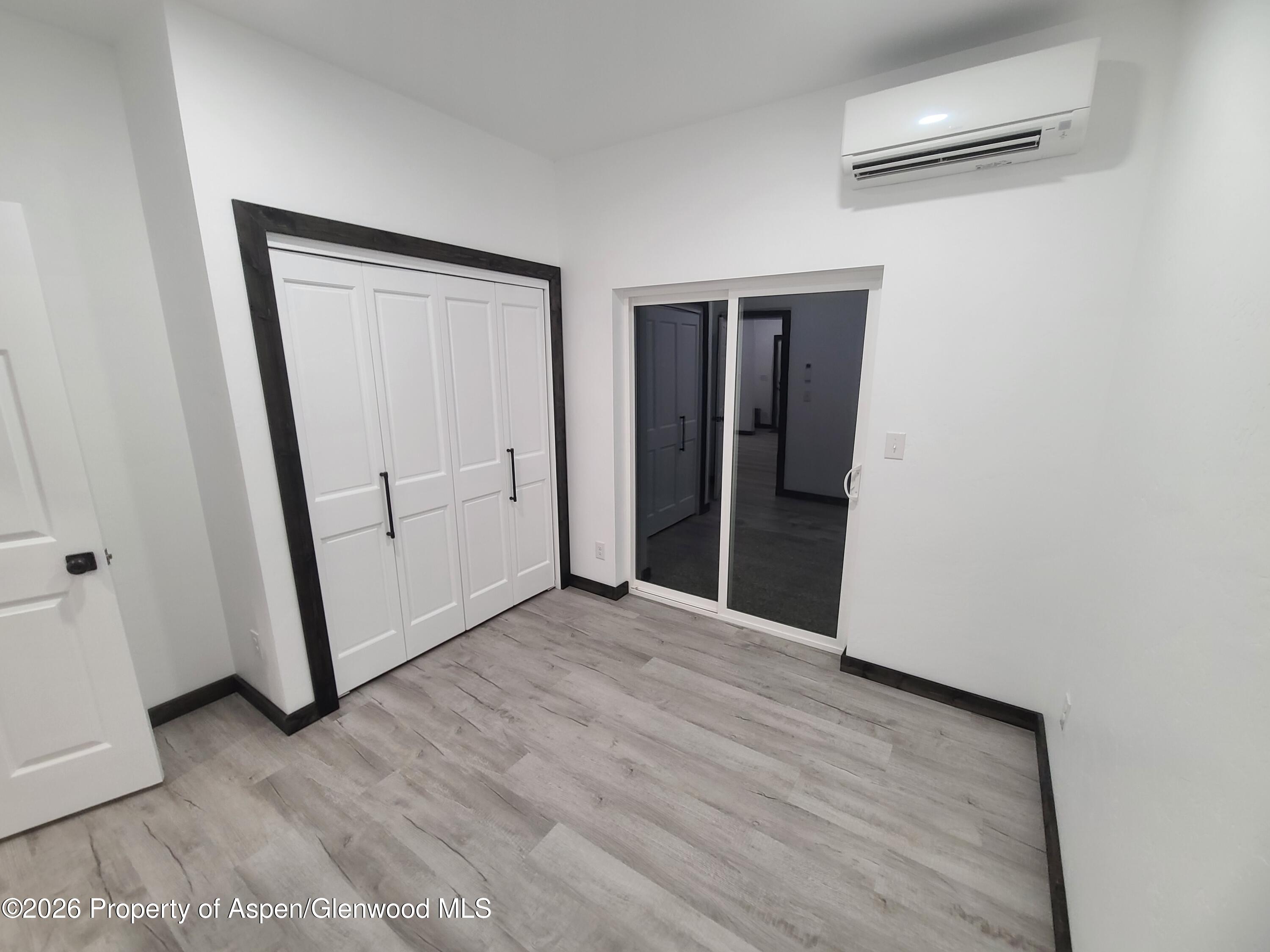 411 County Road 237 Silt, CO 81652 - Photo 42 of 45 an empty room with wooden floor and mirror