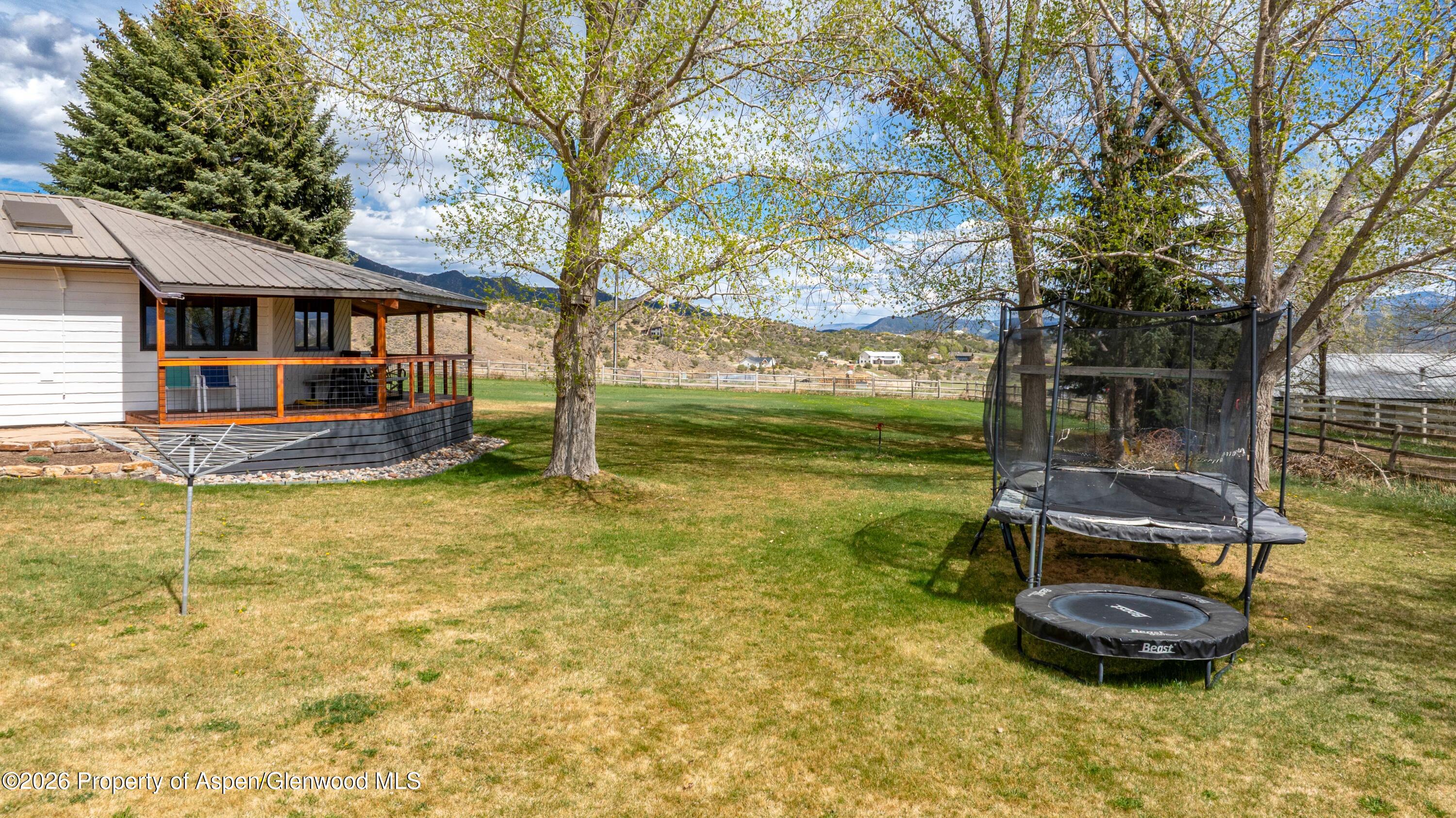 411 County Road 237 Silt, CO 81652 - Photo 6 of 45 a front view of a house with a garden and trees