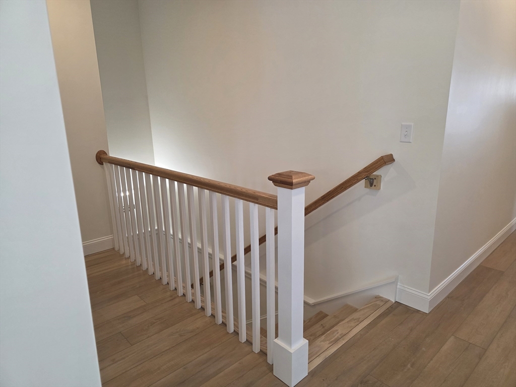 15 Fidelity Drive, Unit 70 Rutland, MA 01543 - Photo 7 of 7 a view of a hallway with wooden floor