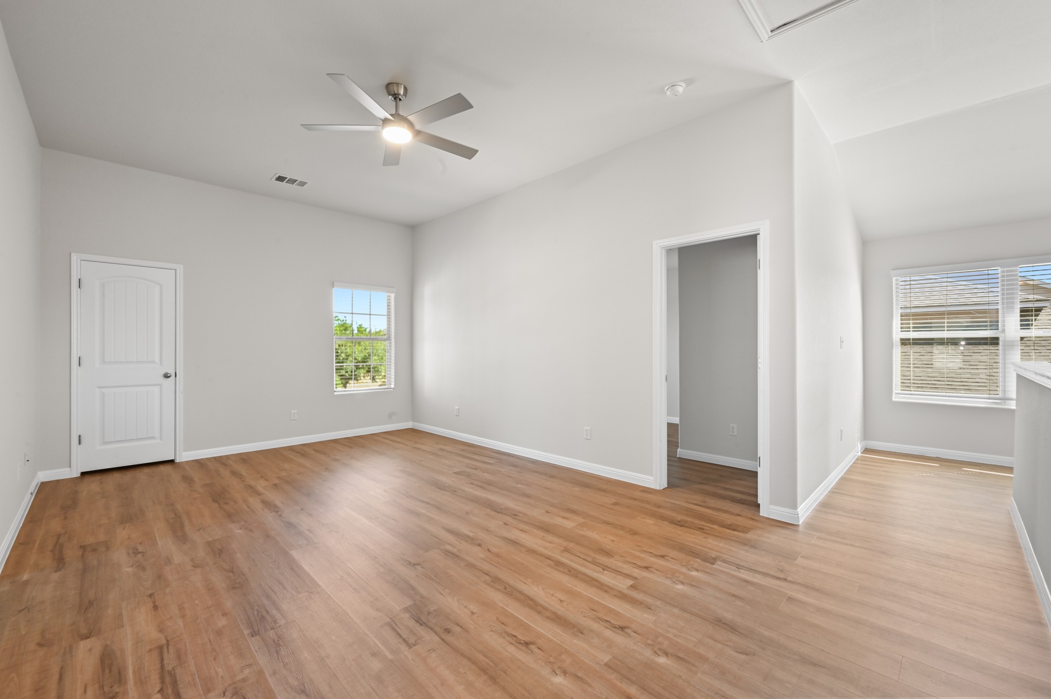 351 Wincliff Drive Buda, TX 78610 - Photo 27 of 40 A generous living area showcases rich hardwood flooring and an overhead ceiling fan for optimal comfort.