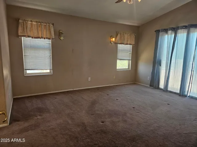 a white toilet sitting next to a white cabinet