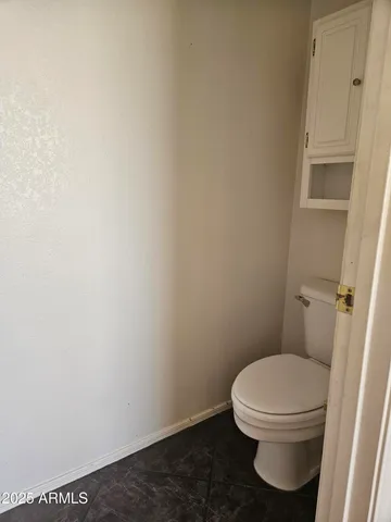 a view of a hallway with a livingroom and furniture