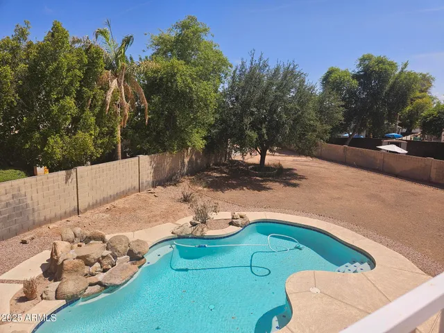 a view of a swimming pool with a yard