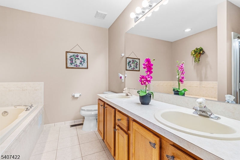 124 Ridge Drive Pompton Lakes, NJ 07442 - Photo 16 of 32 a bathroom with a sink a vanity and a mirror