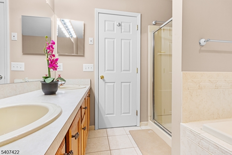 124 Ridge Drive Pompton Lakes, NJ 07442 - Photo 17 of 32 a bathroom with a granite countertop sink a shower and a mirror