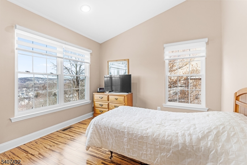 124 Ridge Drive Pompton Lakes, NJ 07442 - Photo 19 of 32 a bedroom with a large bed and a large window