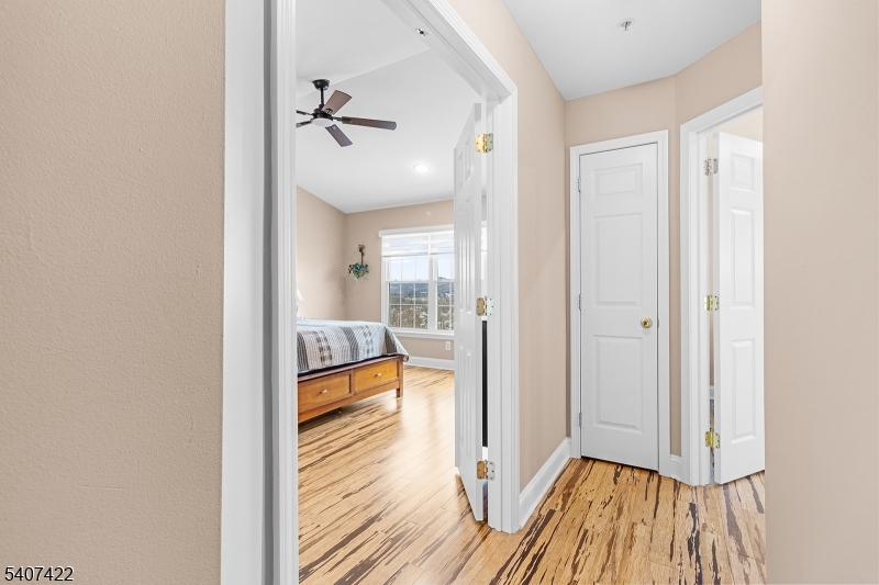124 Ridge Drive Pompton Lakes, NJ 07442 - Photo 23 of 32 a view of a hallway view with wooden floor and a bathroom