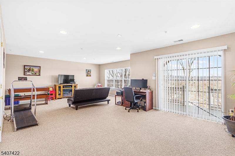 124 Ridge Drive Pompton Lakes, NJ 07442 - Photo 25 of 32 a living room with furniture and a large window