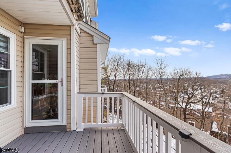 124 Ridge Drive Pompton Lakes, NJ 07442 - Photo 29 of 32 a view of a balcony with wooden floor and fence
