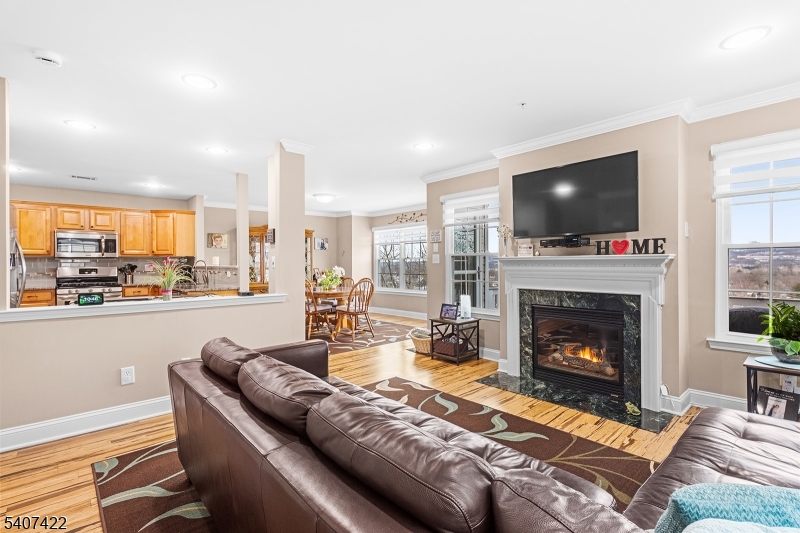 124 Ridge Drive Pompton Lakes, NJ 07442 - Photo 5 of 32 a living room with furniture a flat screen tv and a fireplace