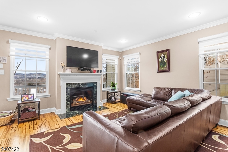 124 Ridge Drive Pompton Lakes, NJ 07442 - Photo 7 of 32 a living room with furniture a flat screen tv and a fireplace