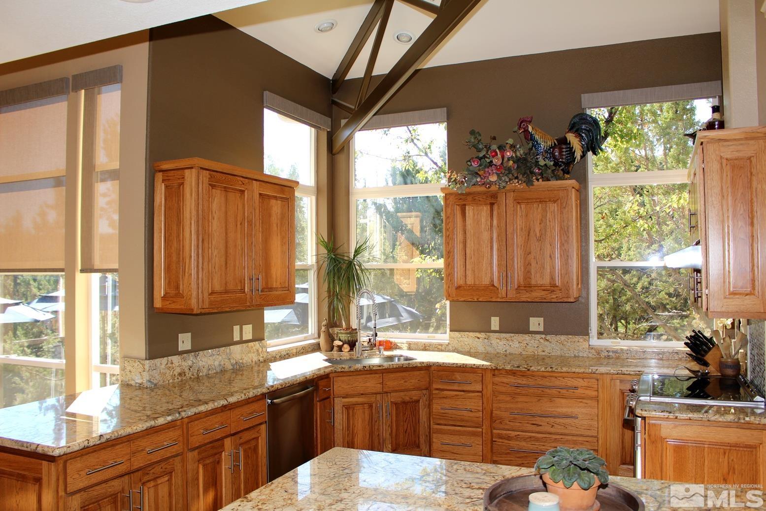 4115 Christy Way Reno, NV 89519 - Photo 5 of 40 a large kitchen with granite countertop a sink window and a counter top space