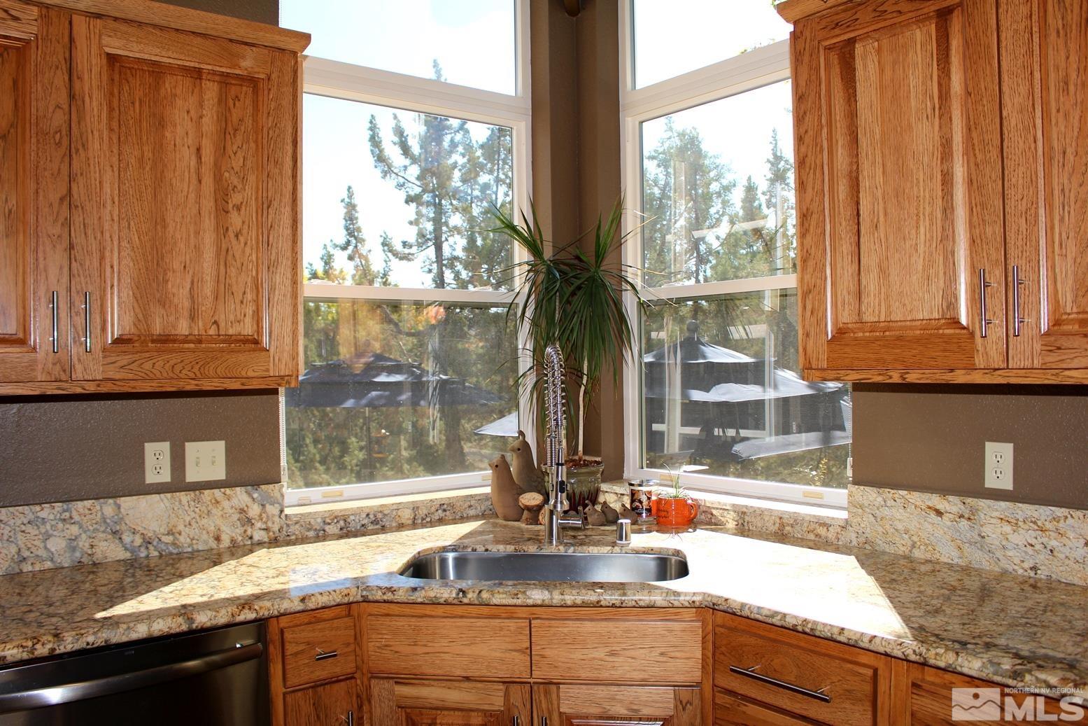 4115 Christy Way Reno, NV 89519 - Photo 6 of 40 a kitchen with granite countertop a sink and a window