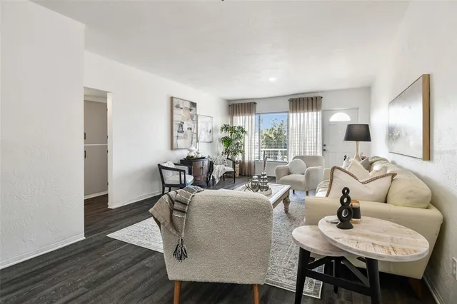 a kitchen with stainless steel appliances granite countertop a refrigerator a stove and a sink with wooden floor